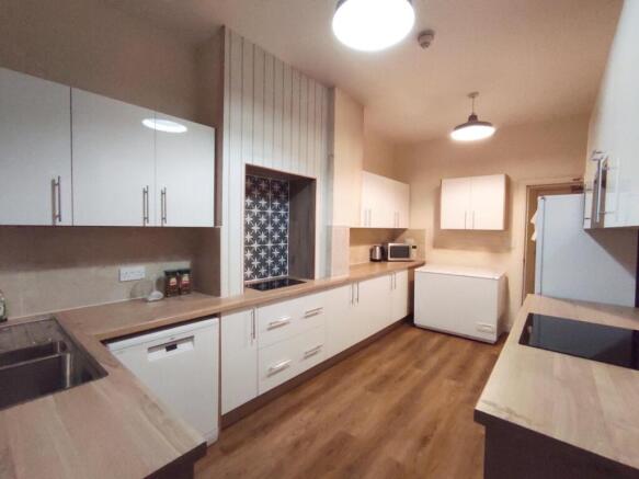 Bright modern kitchen with light wood counterto...