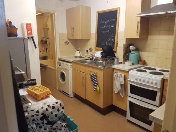 Well-equipped kitchen with oven and washer...