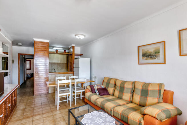 Living and dining area with half-open kitchen
