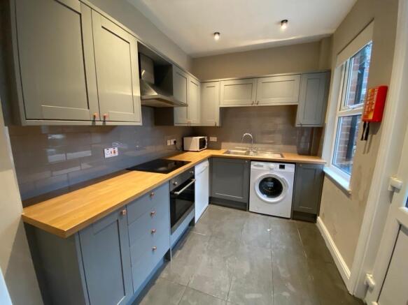 Contemporary fitted kitchen with grey shaker ca...