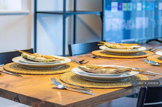 Dining Table Equipped With Complete Cutlery Set.