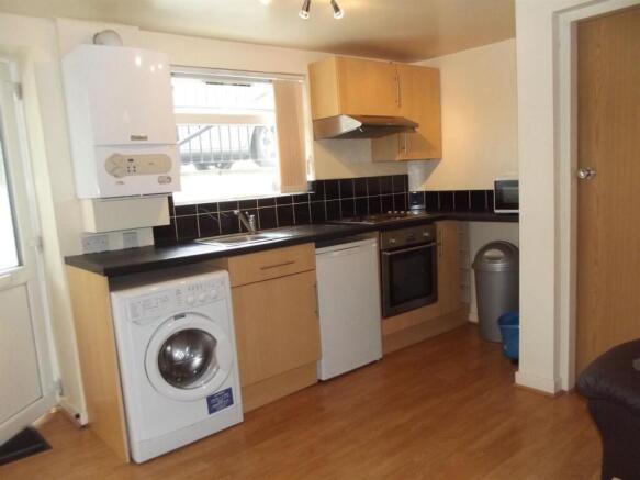 Neat, modern kitchen with wood-effect flooring,...