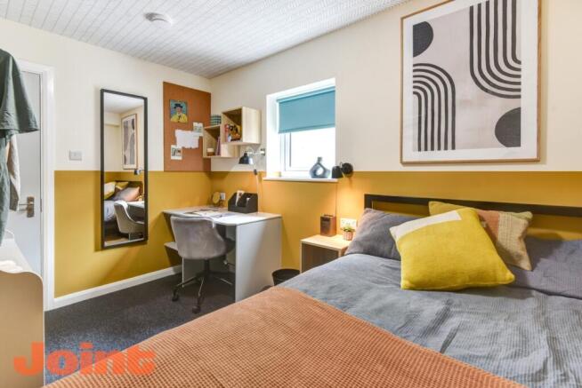 Bright master bedroom with a dedicated study de...