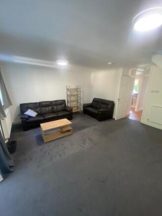 Spacious lounge with comfortable sofas and coff...