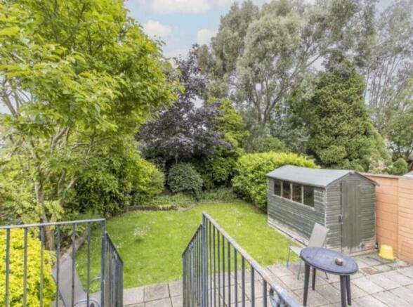 A beautiful, well-maintained garden with lush g...