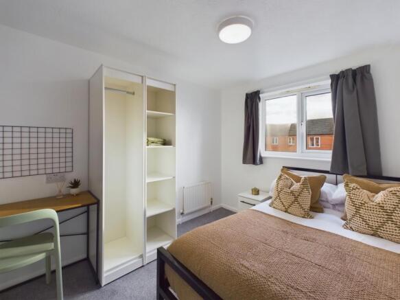 A bright and inviting double bedroom featuring ...