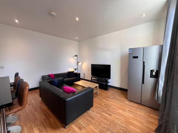 A modern living room featuring comfortable blac...