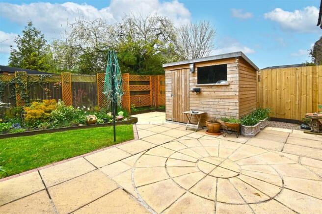 Rear garden - shed and suntrap seating area.jpg