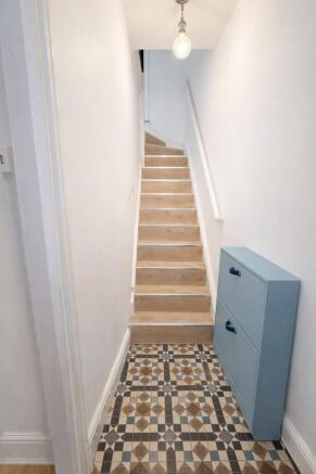 Bright, freshly painted entrance stairwell with...