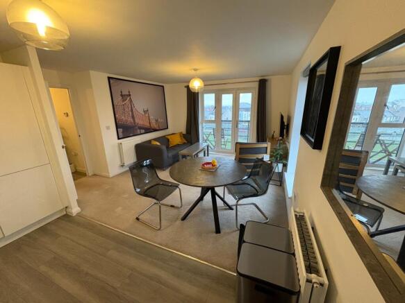 Bright, modern open-plan living area with dinin...