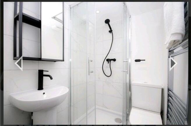 A modern, clean bathroom featuring a spacious s...