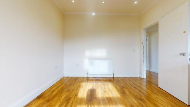 Bright, freshly painted bedroom with polished h...