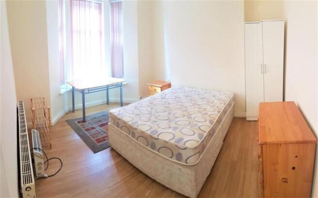 Bright, simply furnished double bedroom with la...