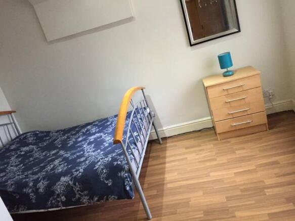 A tidy single bedroom featuring a neat metal-fr...