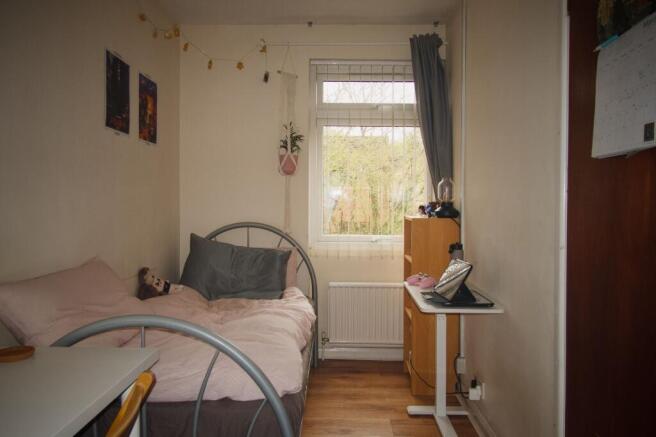 Cozy bedroom with ample storage and natural lig...