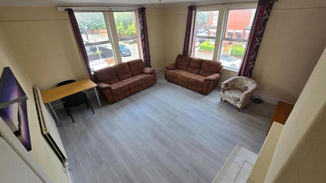 Bright, modern living room with large bay windo...