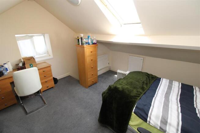 Bright attic bedroom with skylight and study de...