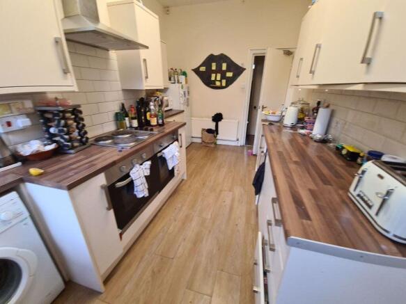 A well-maintained kitchen featuring wooden coun...