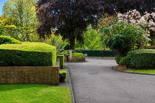 Lush, well-maintained garden with mature trees...