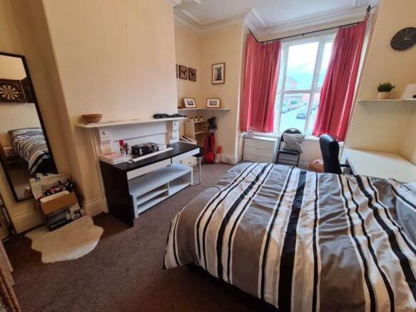 A spacious and inviting master bedroom featurin...
