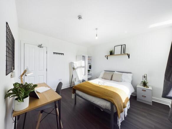 A bright and spacious double bedroom featuring ...