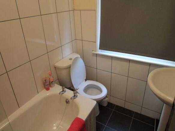 A functional bathroom featuring a standard toil...