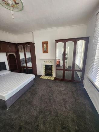 Bright, well-maintained bedroom with a comforta...