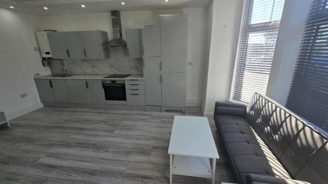 Bright open-plan living area with a modern fitt...