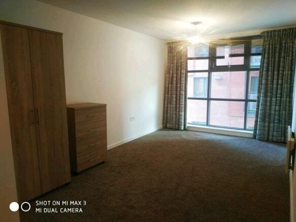 Bright and spacious bedroom with large windows...
