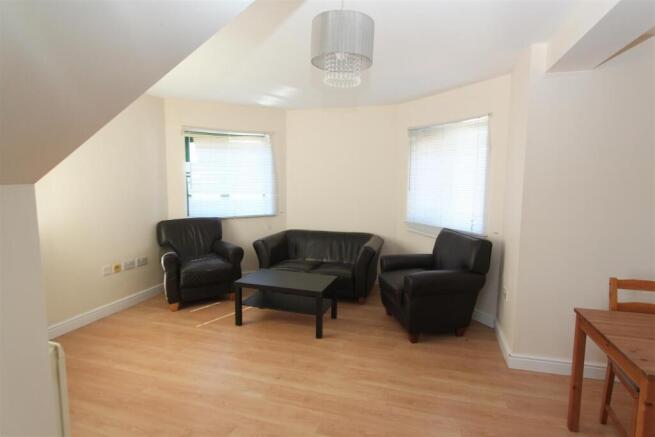 Spacious lounge with leather seating and window...