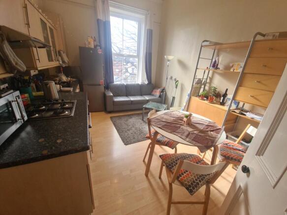 A bright and welcoming kitchen featuring wooden...