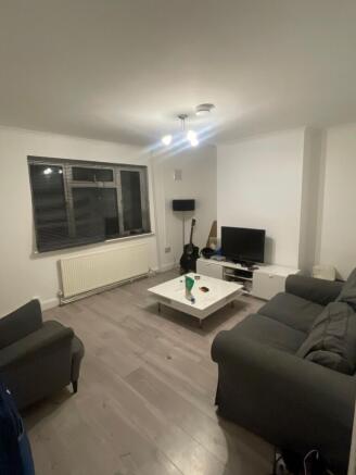 Bright, neutral living room with modern light w...