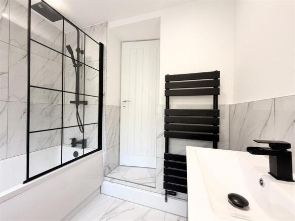 Modern bathroom with chic marble-effect tiling....