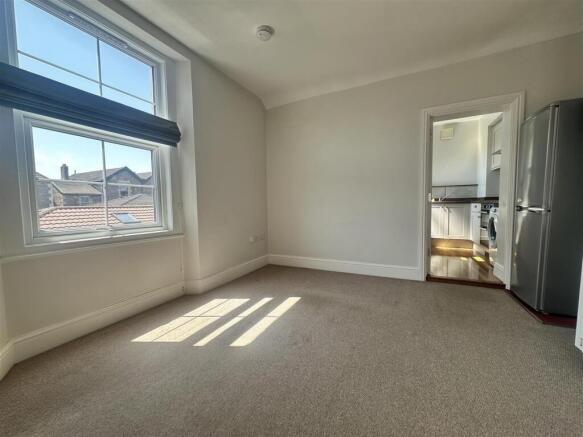 Bright, airy living space with large window...