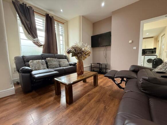Well-presented living room with comfortable lea...