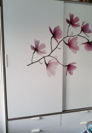 Modern built-in wardrobe with sliding doors and...