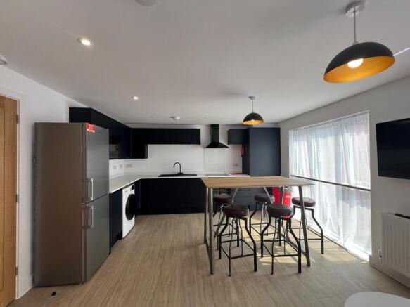 Bright modern open-plan kitchen with sleek dark...