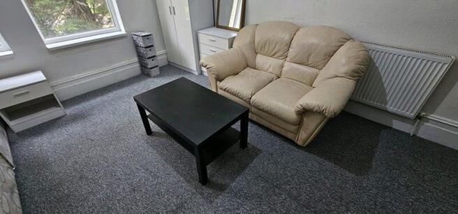 Bright furnished living room with a comfy two-s...