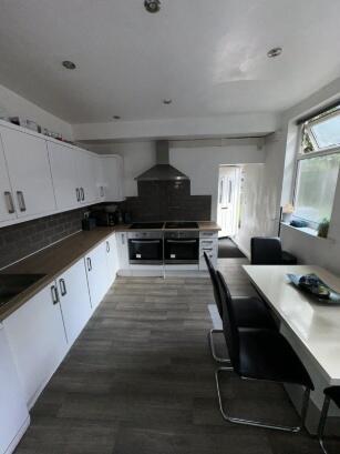 Bright and modern kitchen featuring ample count...
