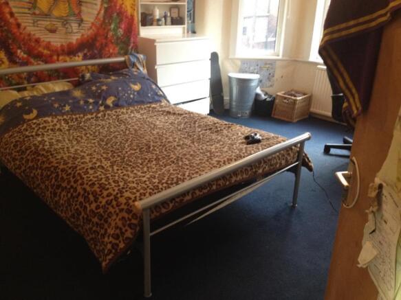 A cozy master bedroom featuring a double bed wi...