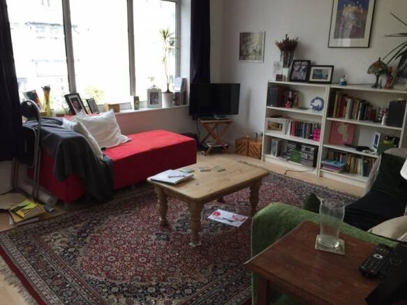Bright living room with large windows and stora...