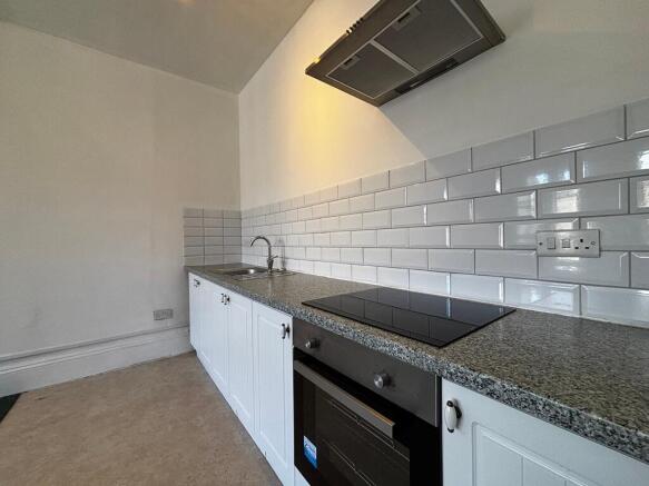 Modern kitchen with sleek subway tiles...