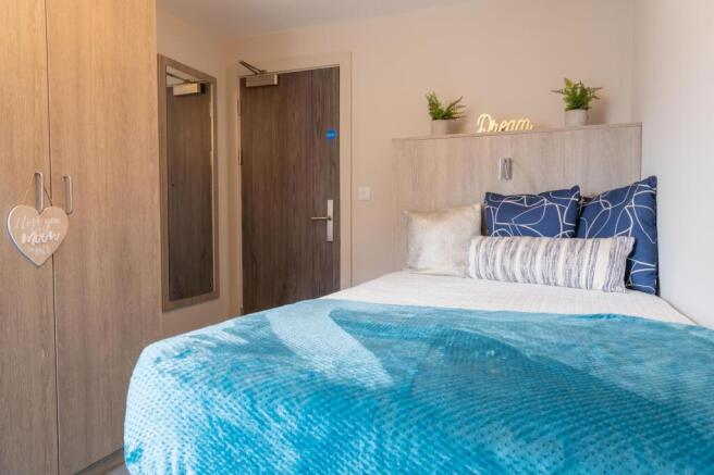 Bright, neatly styled single bedroom with a com...