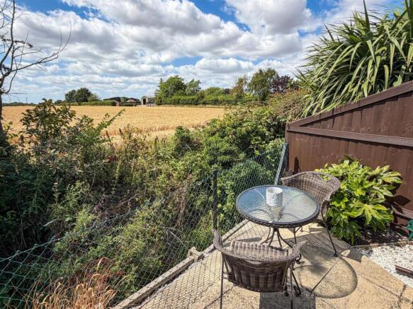 REAR PATIO AREA WITH FIELD VIEWS