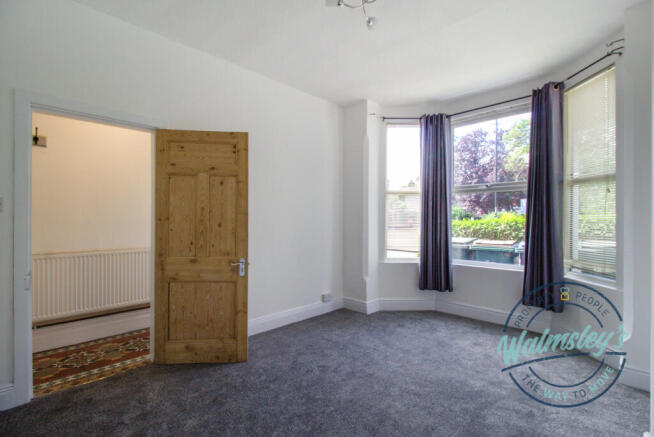 Sitting room with bay towards hallway