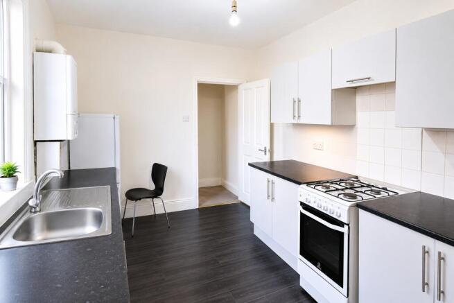 Bright modern kitchen with sleek white cabinets...