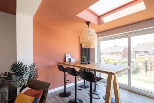Bright dining area with skylight and garden vie...