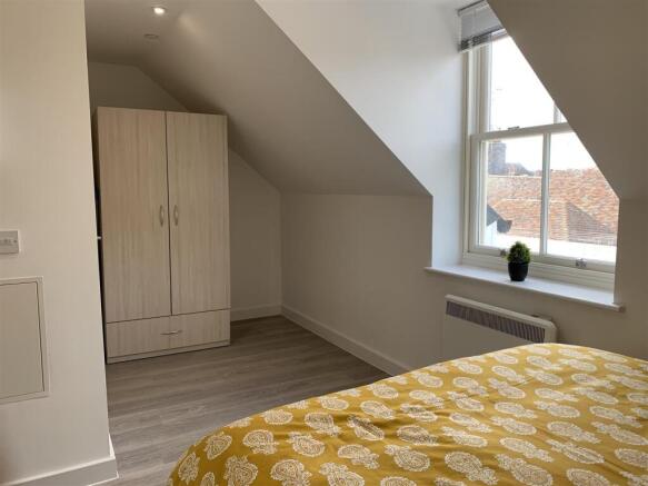 Bright attic double bedroom with fitted wardrob...