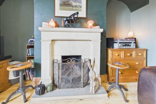 A beautiful fireplace is the focal point of this r
