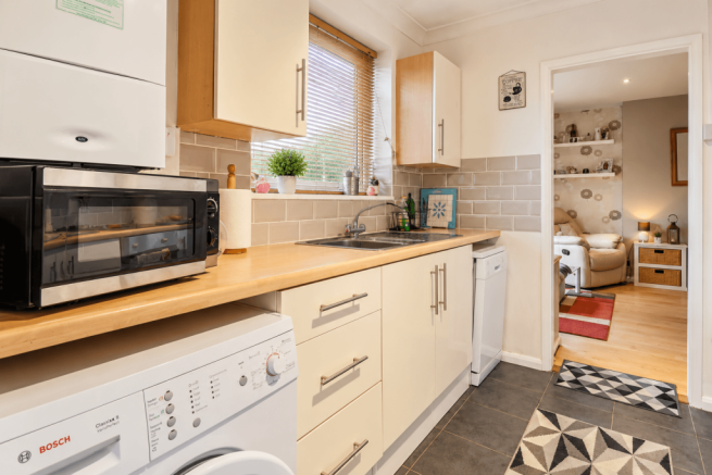 Warm Modern Galley Kitchen and Living Room